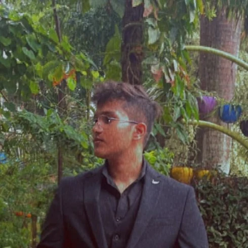Nikhil Joe Varghese wearing a black suit outdoors